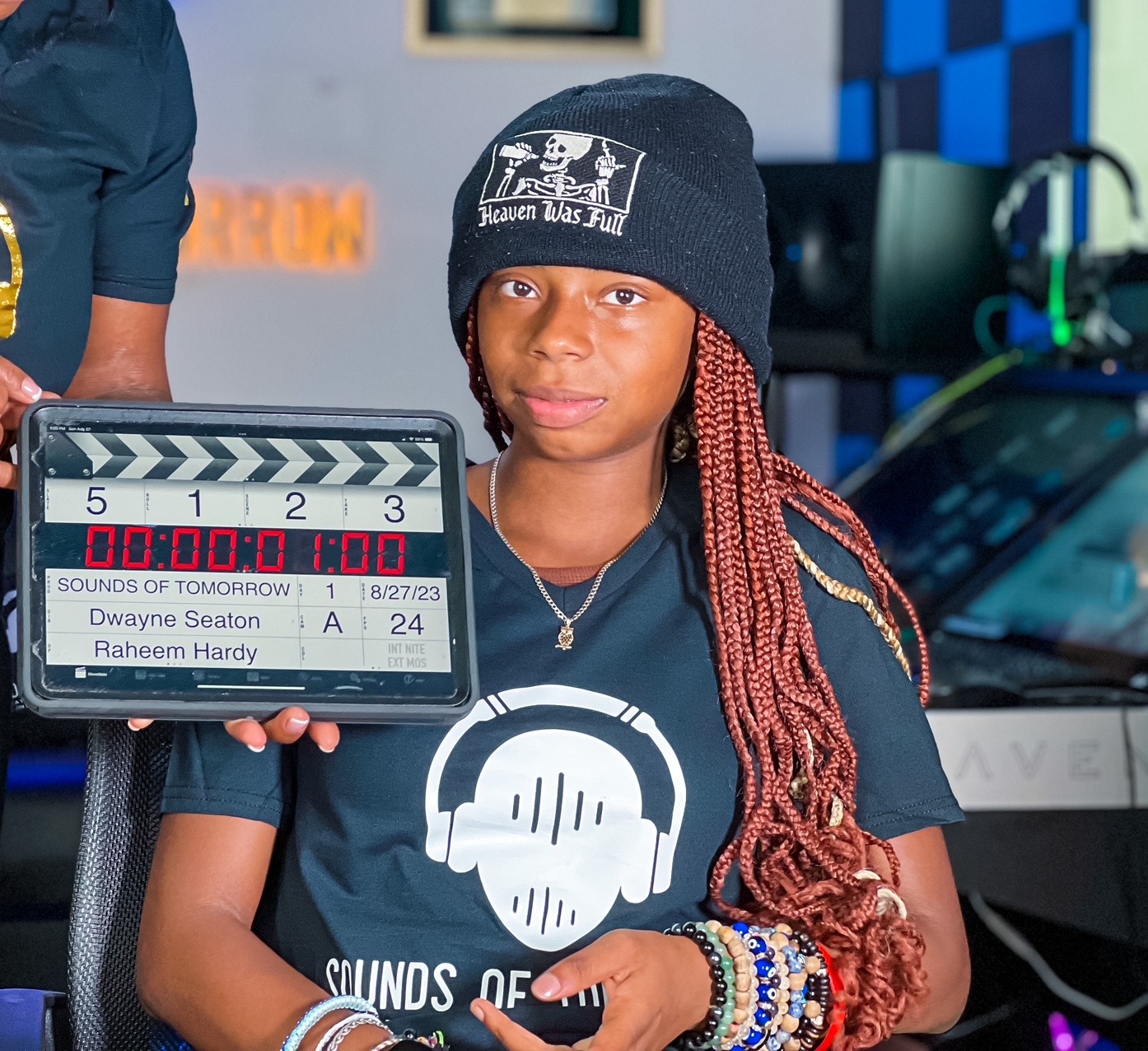 Creative participant wearing SOT merchandise with a film slate
