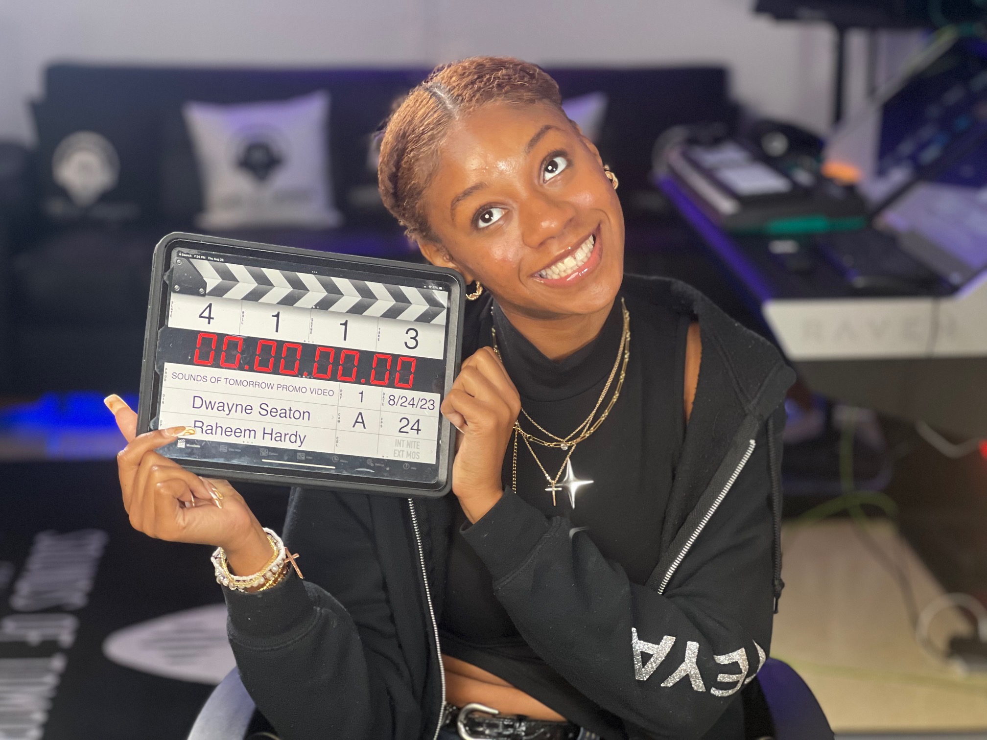 Creative participant holding a digital slate for an SOT production