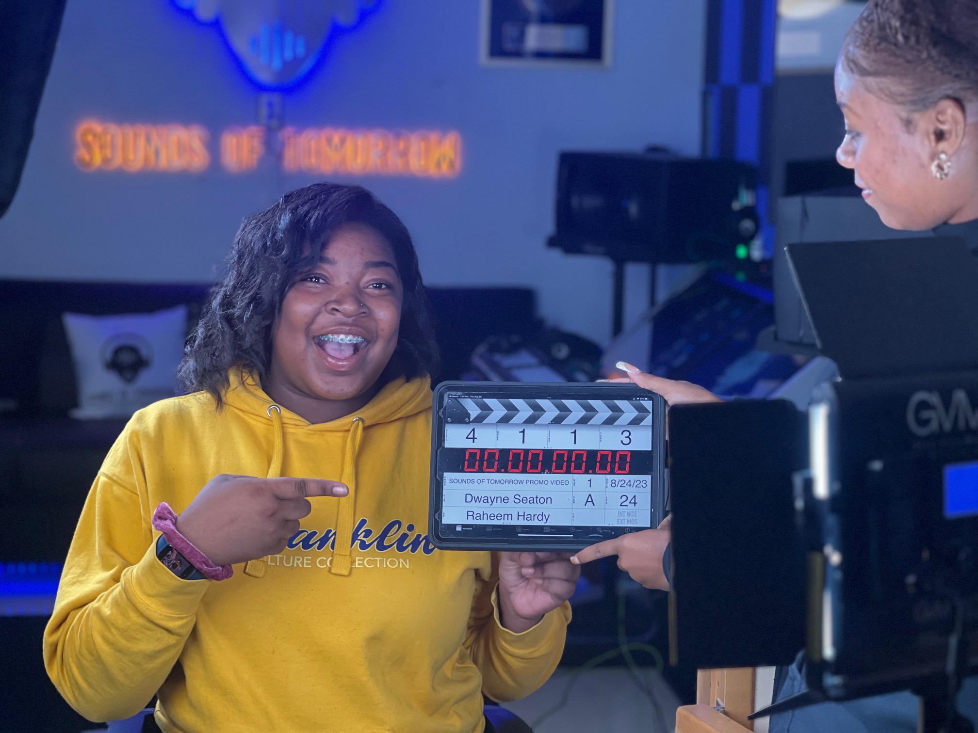 Sounds of Tomorrow film production with a digital slate and camera